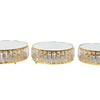 A set of three crystal and gold-edged metal cake stands.