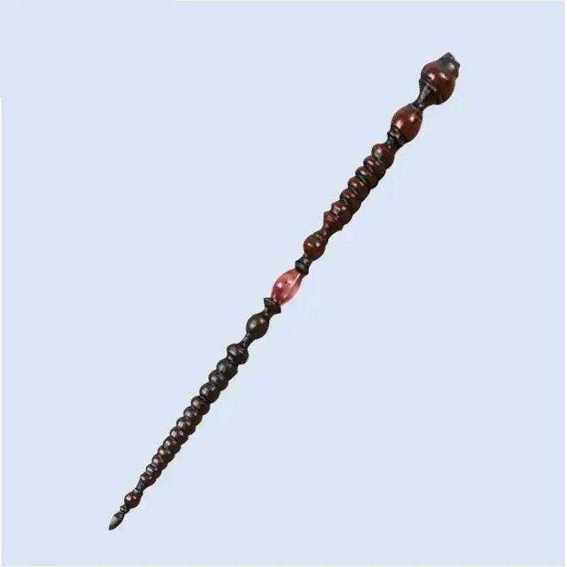 A collection of dark brown, character-inspired metal and resin magic wands arranged diagonally.