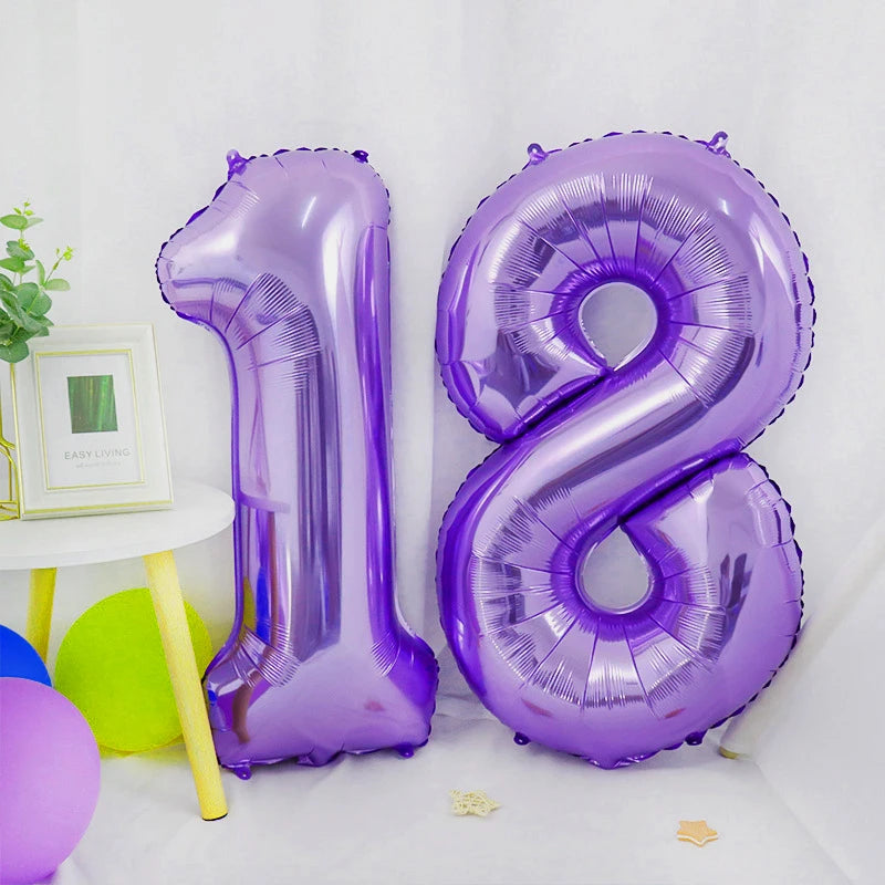 A purple foil number balloon shaped like the number 18 is displayed on a white surface.