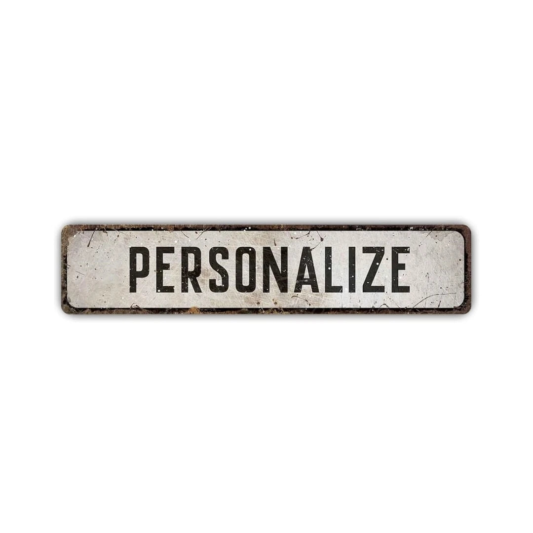 A rectangular, weathered metal sign with the word PERSONALIZE engraved on it.