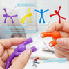 Hand demonstrates strong magnetism of colorful silicone resin magnets used for decoration and notes.
