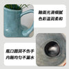 A light blue ceramic vase with a handle and a round opening, featuring a warm glaze.