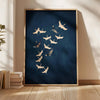 A framed canvas wall art featuring a silhouette of a Japanese crane in white against a dark blue background.