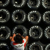 A close-up view of various Goodyear racing tires mounted on a black wall display.