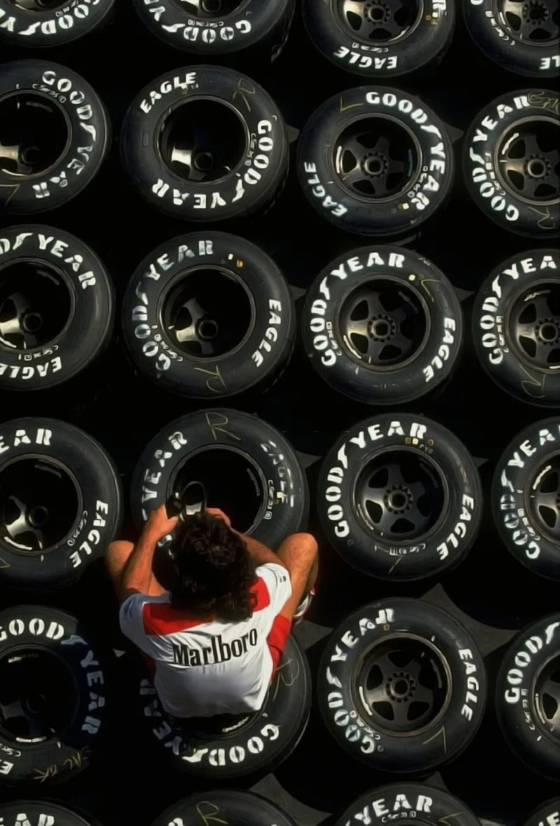 A close-up view of various Goodyear racing tires mounted on a black wall display.
