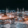 Night view of the Masjid an Nabawi with illuminated minarets and surrounding architecture.