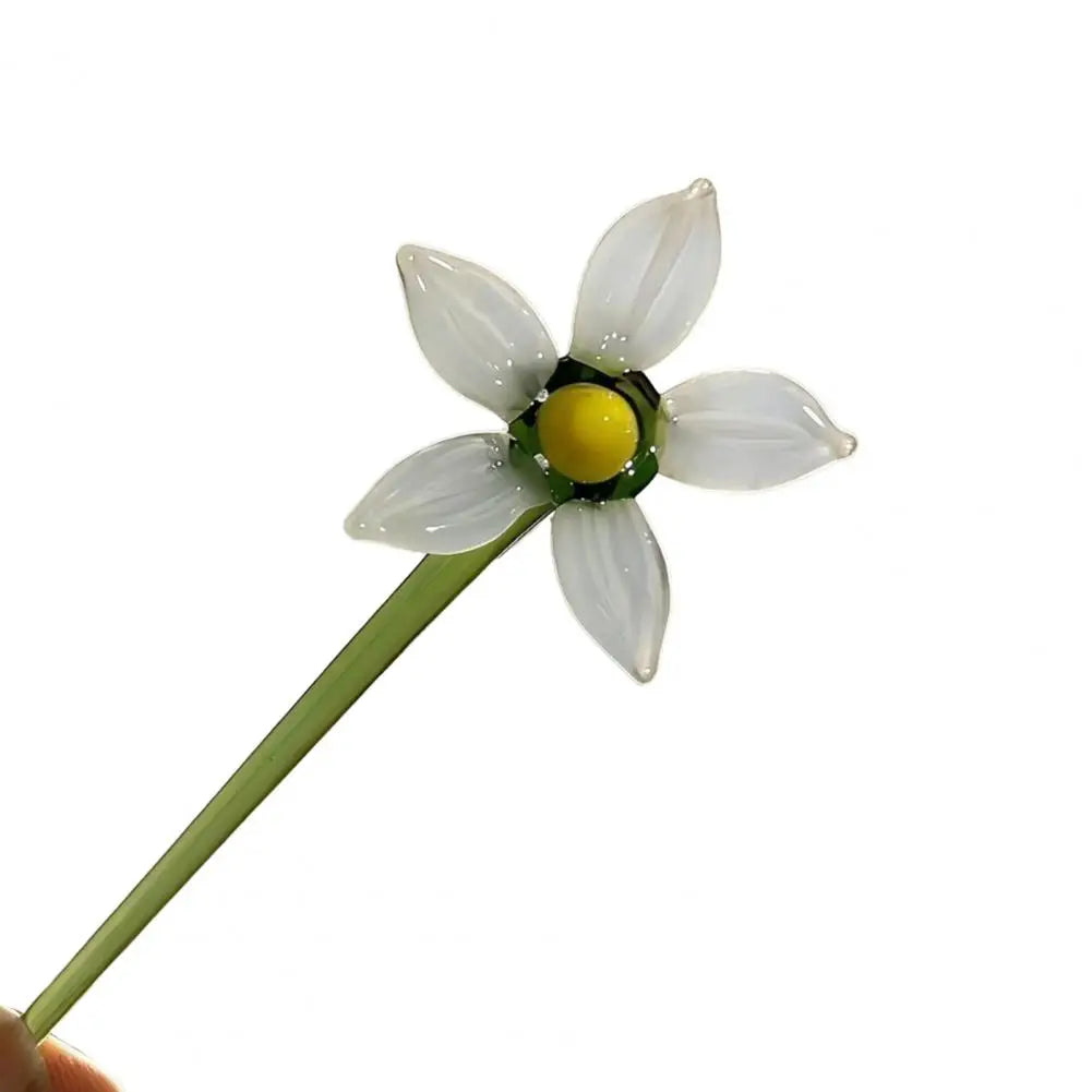 Handcrafted blue glass flower sculpture with white petals and a yellow center