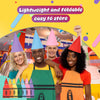 A group of four people wearing colorful crayon apron and cone hat costumes.
