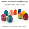 A collection of 9 colorful twisted dragon eggs made from 3D printed material, showing various shades of pink, orange, yellow,