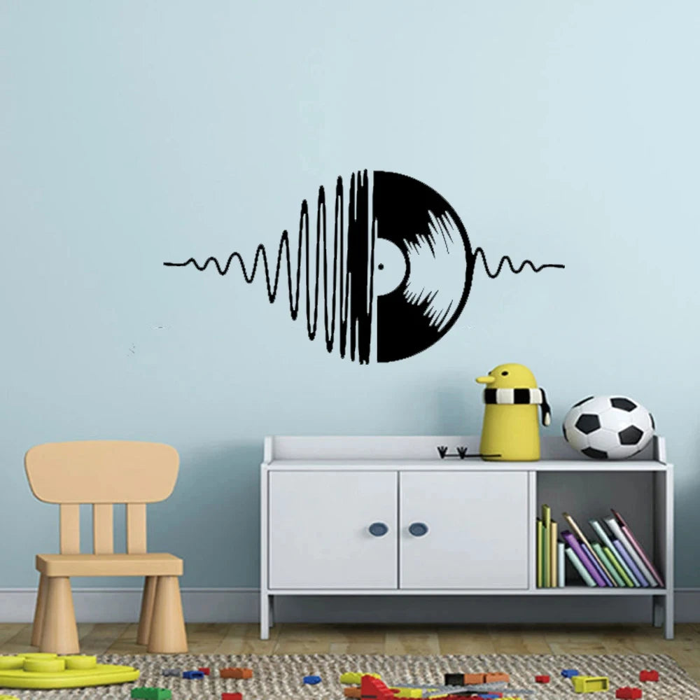 A black vinyl record design with sound waves is displayed on a light blue wall above a white cabinet.