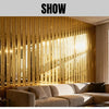 Interior design featuring a wall covered in vertical metallic gold striped wallpaper and a beige sofa.
