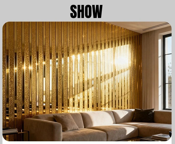 Interior design featuring a wall covered in vertical metallic gold striped wallpaper and a beige sofa.