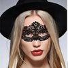 A blonde woman wearing a black wide-brim hat and a black lace eye mask for a masquerade event.