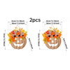 A set of two decorative plastic pumpkin door hangers with floral accents.