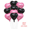 A bundle of ten pink and black heart-shaped foil balloons tied together by strings.