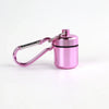 A small pink pill organizer is attached to a keyring, designed as a keychain.