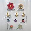A collection of reusable fridge magnets featuring various floral and insect shapes in red, yellow, and purple colors.