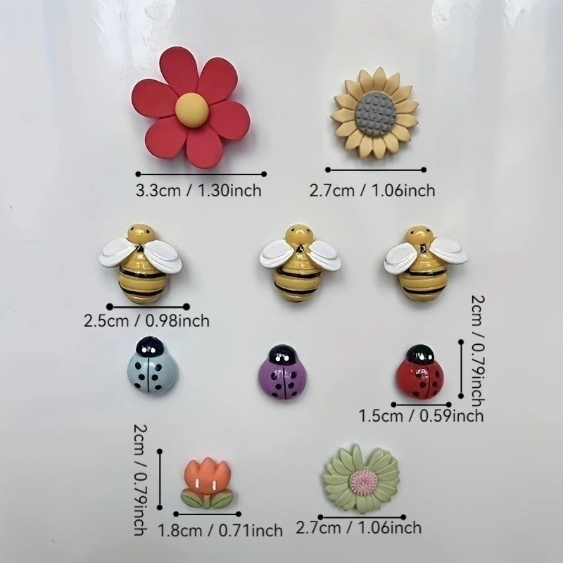 A collection of reusable fridge magnets featuring various floral and insect shapes in red, yellow, and purple colors.