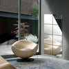 A beige decorative acrylic mirror mosaic tile panel reflecting a room interior and an armchair.