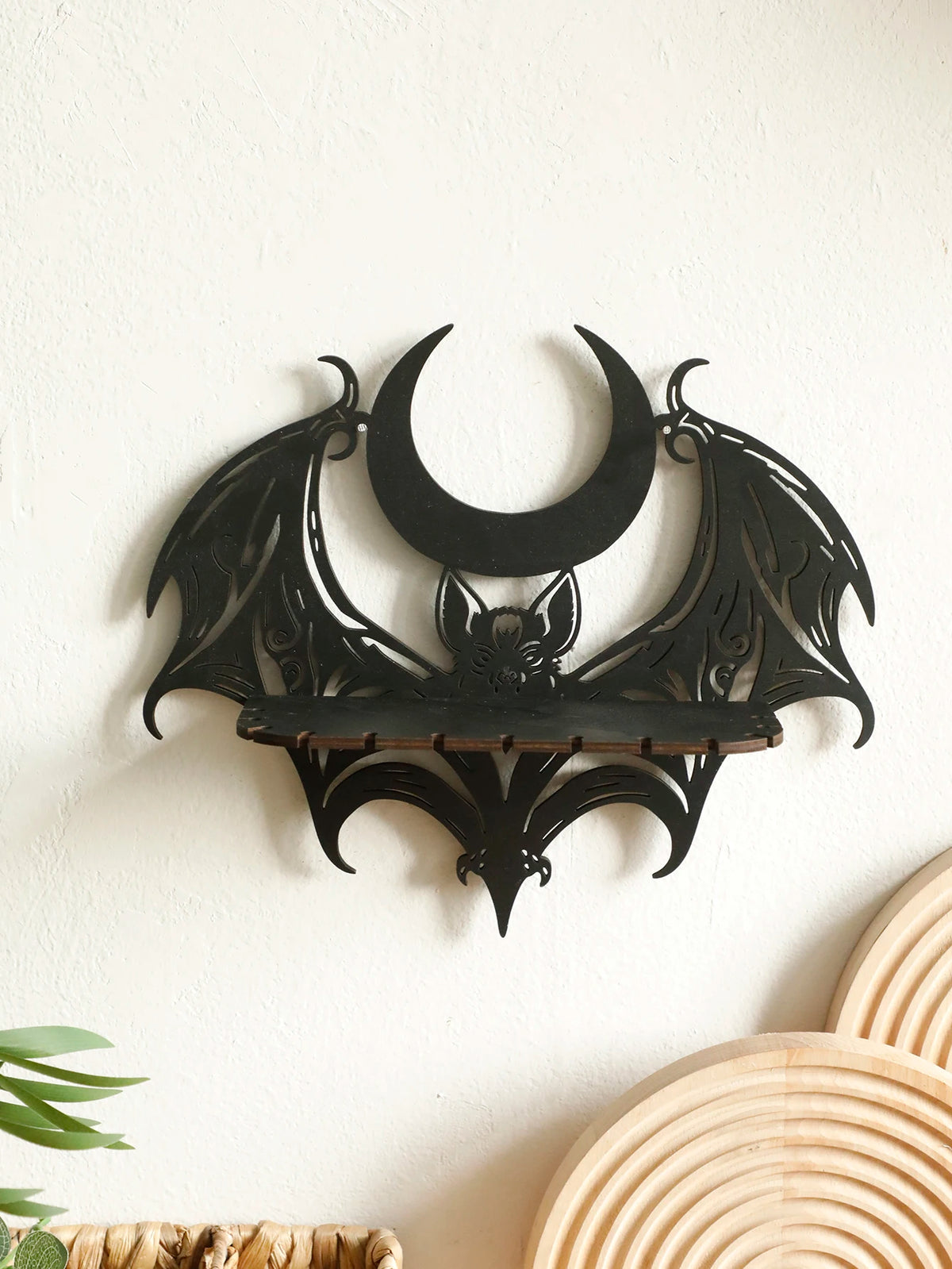 Black gothic bat and moon floating wall decor silhouette on a white wall.