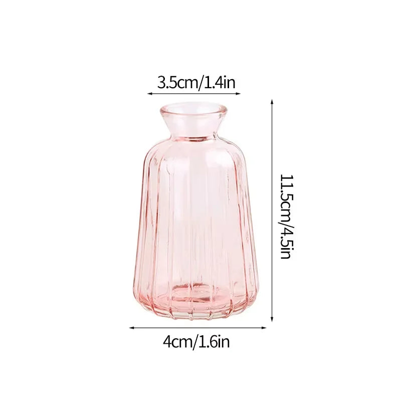 A modern clear glass vase with a rounded neck and tapered body, pink in color.