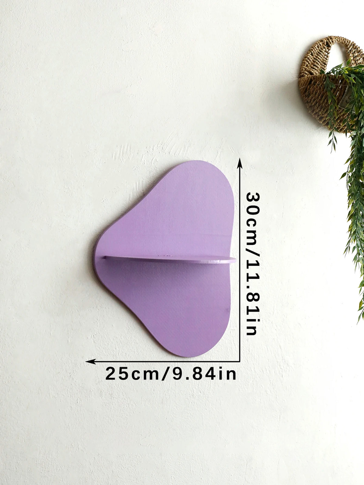 A purple cherry-shaped wooden wall shelf mounted on a white wall.