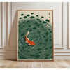 A framed canvas print featuring a green and white circular pattern with an orange fish in the center.