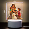 A 3D LED night light depicting a family of Jesus and children in warm tones on a square panel.