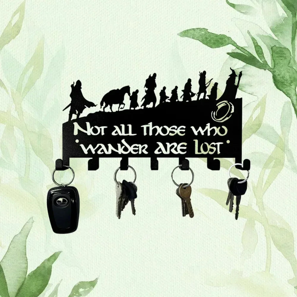 Black metal wall-mounted key holder with seven hooks displayed against a light green watercolor background.