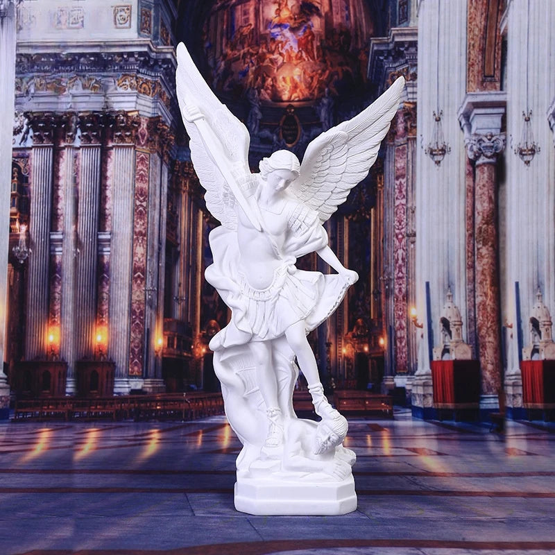 White resin figurine of Saint Michael Archangel with large wings standing on a pedestal.