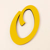 A bright yellow, oval-shaped acrylic letter cutout against a light background.
