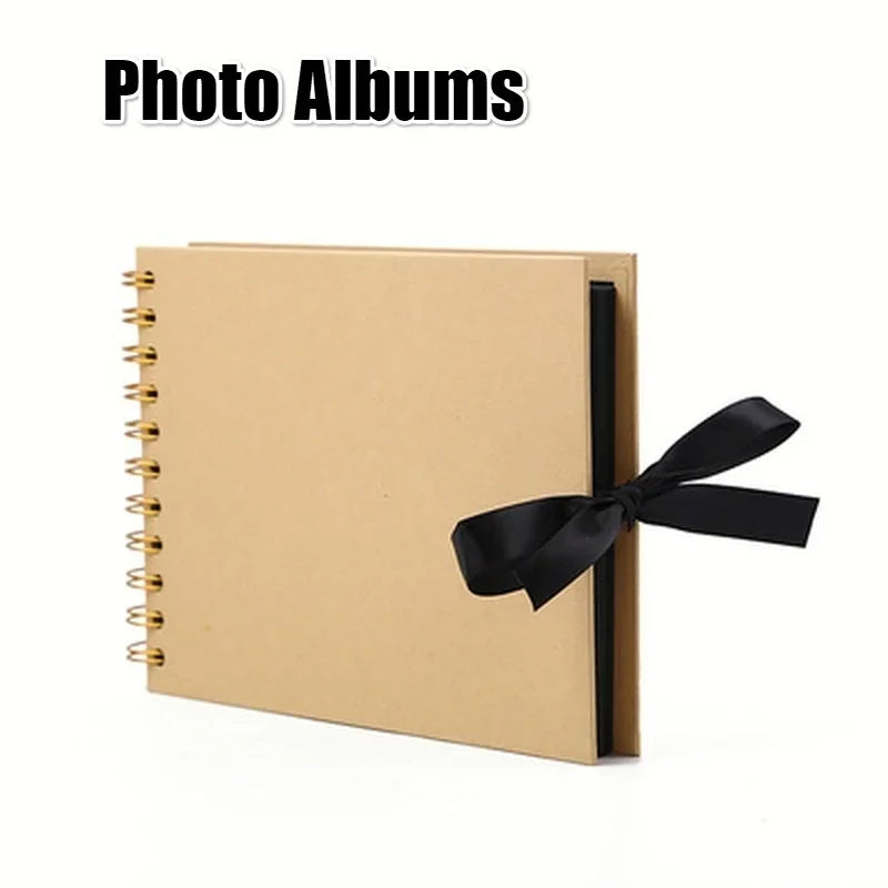 A tan spiral-bound photo album with a black ribbon closure.