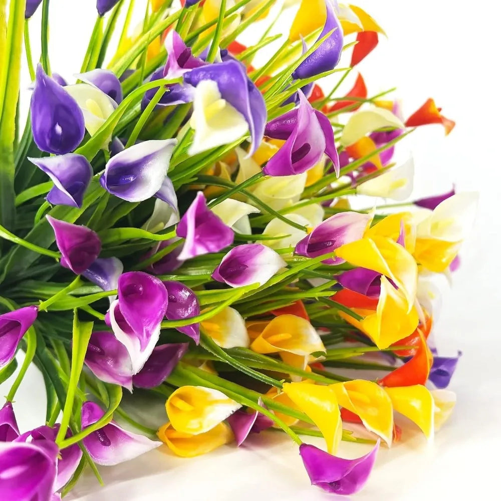 A bouquet of artificial purple and yellow calla lilies with green stems for home decor
