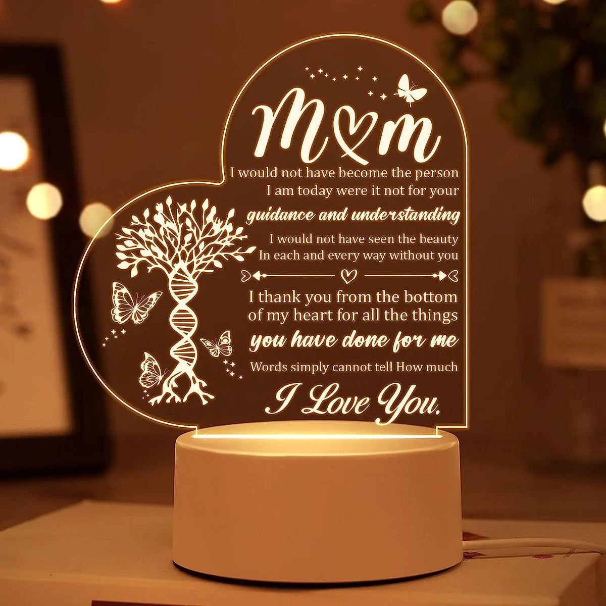 A decorative acrylic night light featuring a heart shape engraved with 'M&M' and loving sentiments.