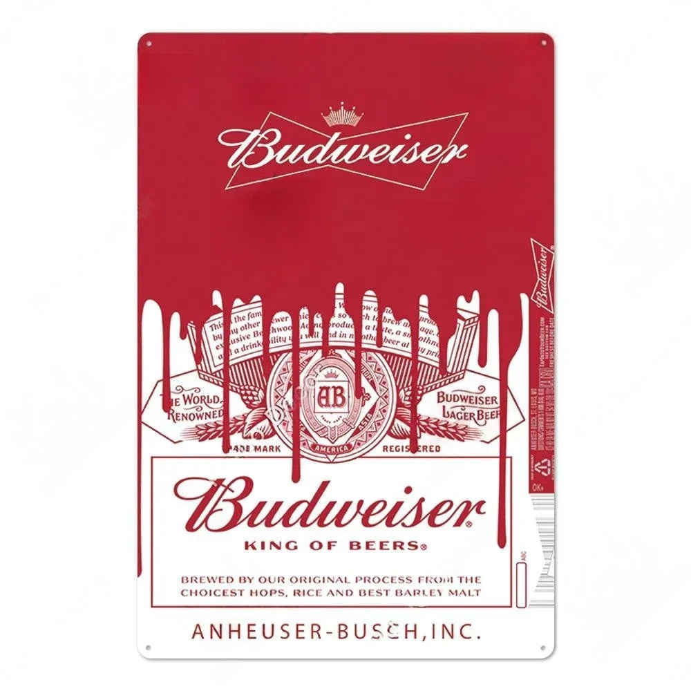 A vintage red metal sign for Budweiser featuring the King of Beers logo and text.