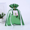 A green festive drawstring gift bag with a gold tag featuring a Christmas tree and snowman design.