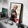 A framed poster of the Vinland Saga anime featuring a character, displayed on a white shelf next to a model car.