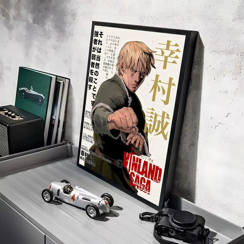 A framed poster of the Vinland Saga anime featuring a character, displayed on a white shelf next to a model car.