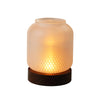 A vintage wooden candle lantern with a glass cover emits a warm, glowing light.