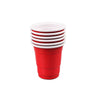 A stack of five red disposable shot glasses with white lids and a red cup visible.