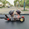 A set of cute couple balloon car ornaments featuring two figures and a small pink animal on a wooden branch.