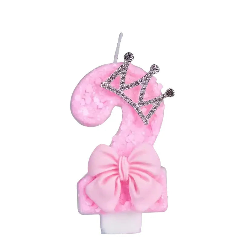 Pink princess birthday candle with a crown and bow for cake topper