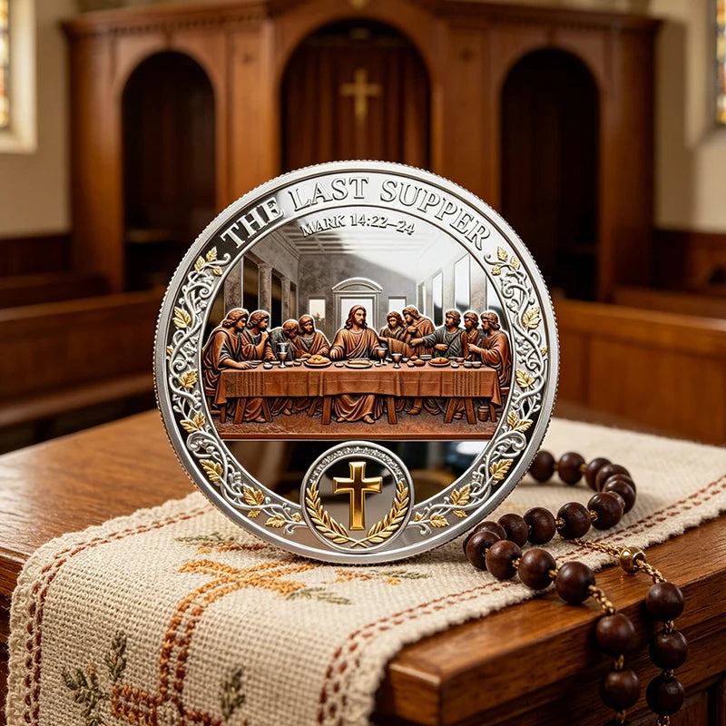 A commemorative coin set depicting Jesus' Last Supper with a cross design, displayed on a wooden surface.