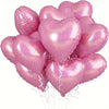 A bunch of ten pink heart-shaped foil balloons tied together, sparkling with glitter.