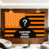 A large tapestry featuring the American flag design with a question mark overlay on an orange and black striped background.