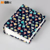 A colorful photo memory album featuring cartoon mushroom designs on the cover.