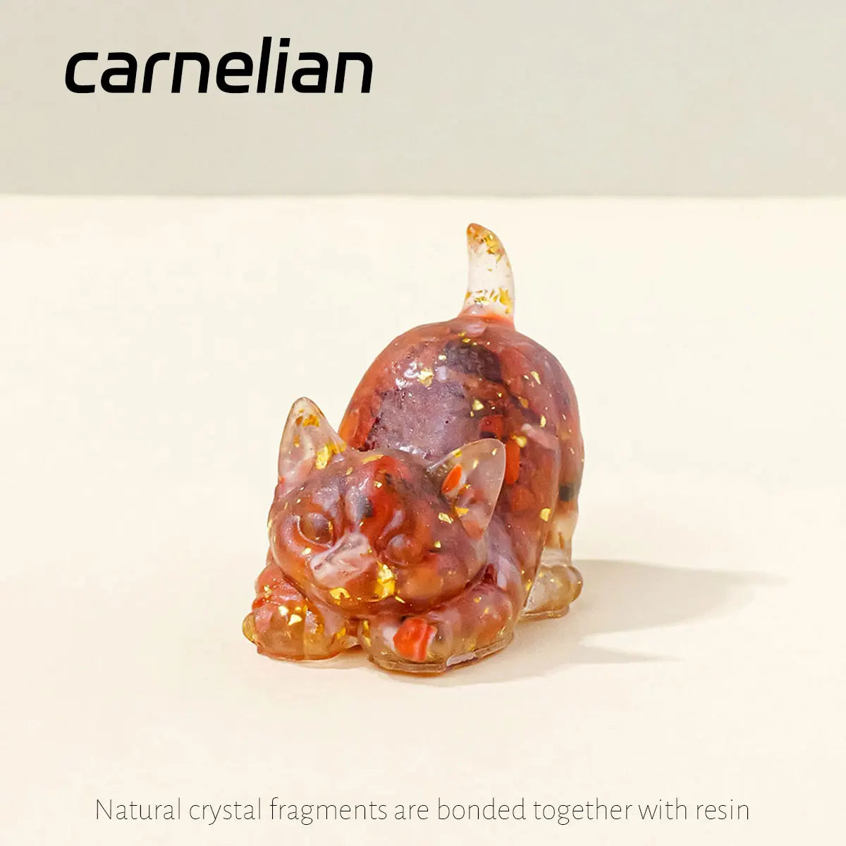 A small, translucent amber-colored crystal figurine shaped like a crouching cat.