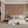 A bedroom interior featuring light wood slat wall panels and a beige bed with white linens.