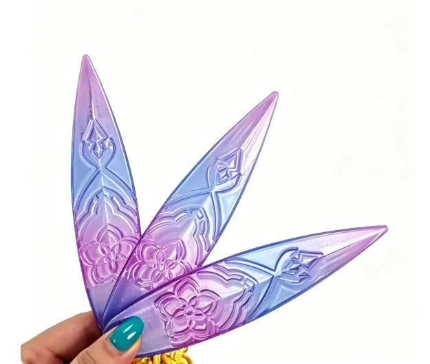 A hand holds a purple and blue Lumi Symbol Sword cosplay prop with intricate floral patterns.