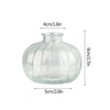 Modern clear glass vase with a rounded body and narrow neck, measuring 9cm high and 5cm wide.
